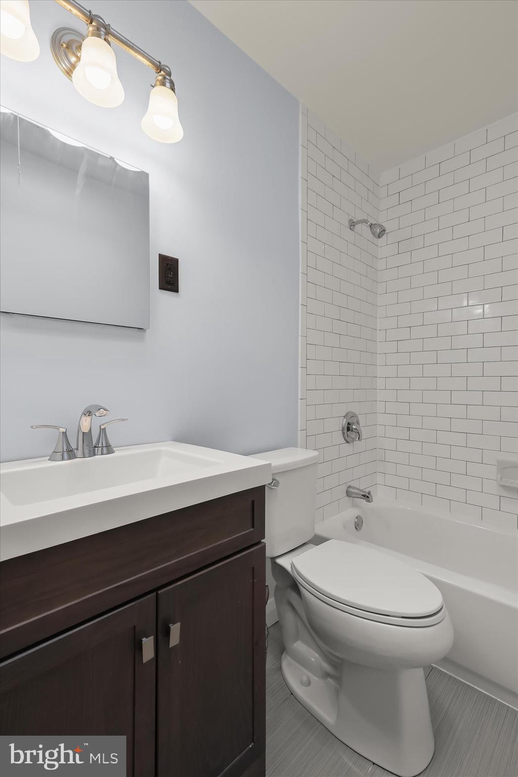 8307 Ridgely Oak Road Baltimore, MD 21234 - Photo 16 of 30 a bathroom with a sink a toilet and a mirror