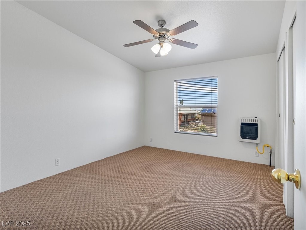 70 West Bonanza Road Las Vegas, NV 89124 - Photo 32 of 71 Carpeted empty room featuring heating unit and ceiling fan