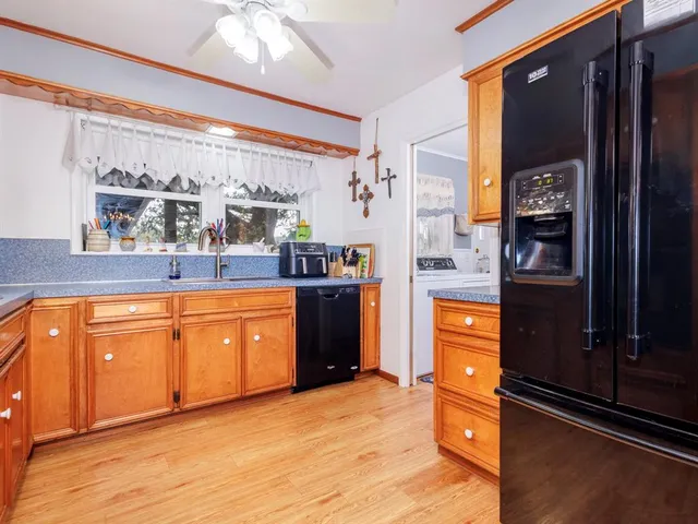 a kitchen with stainless steel appliances granite countertop a refrigerator and a stove top oven