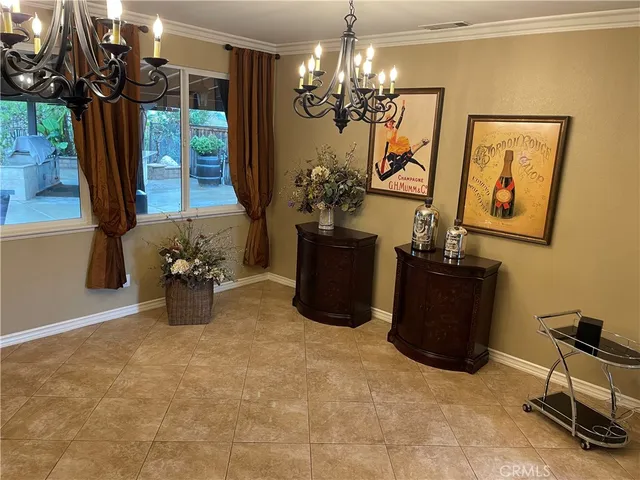 a view of a room with furniture and a chandelier
