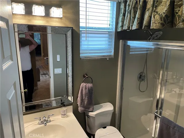 a bathroom with a toilet sink and shower