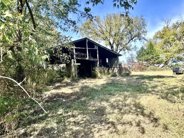 a view of a yard with large trees