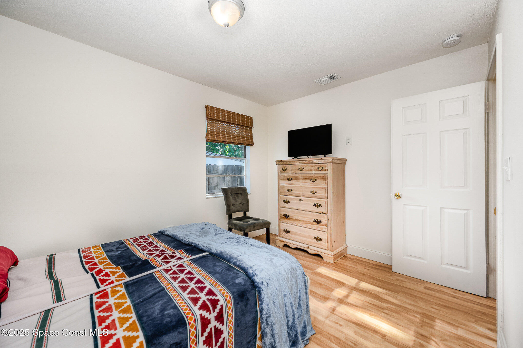 233 Beverly Road Cocoa, FL 32922 - Photo 12 of 20 a bedroom with a bed and a television