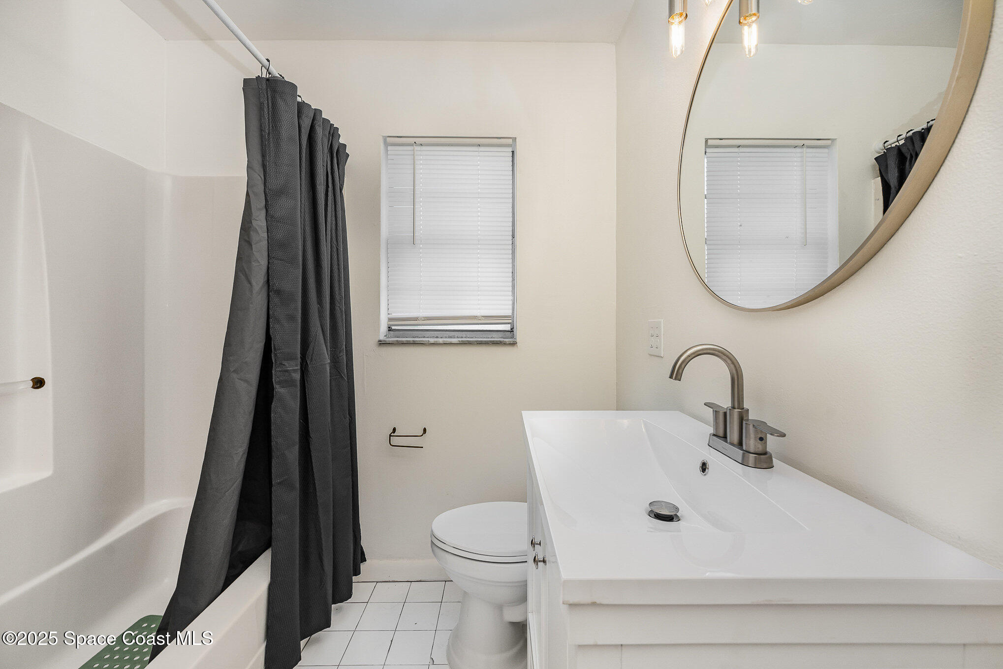 233 Beverly Road Cocoa, FL 32922 - Photo 13 of 20 a bathroom with a sink toilet and a mirror