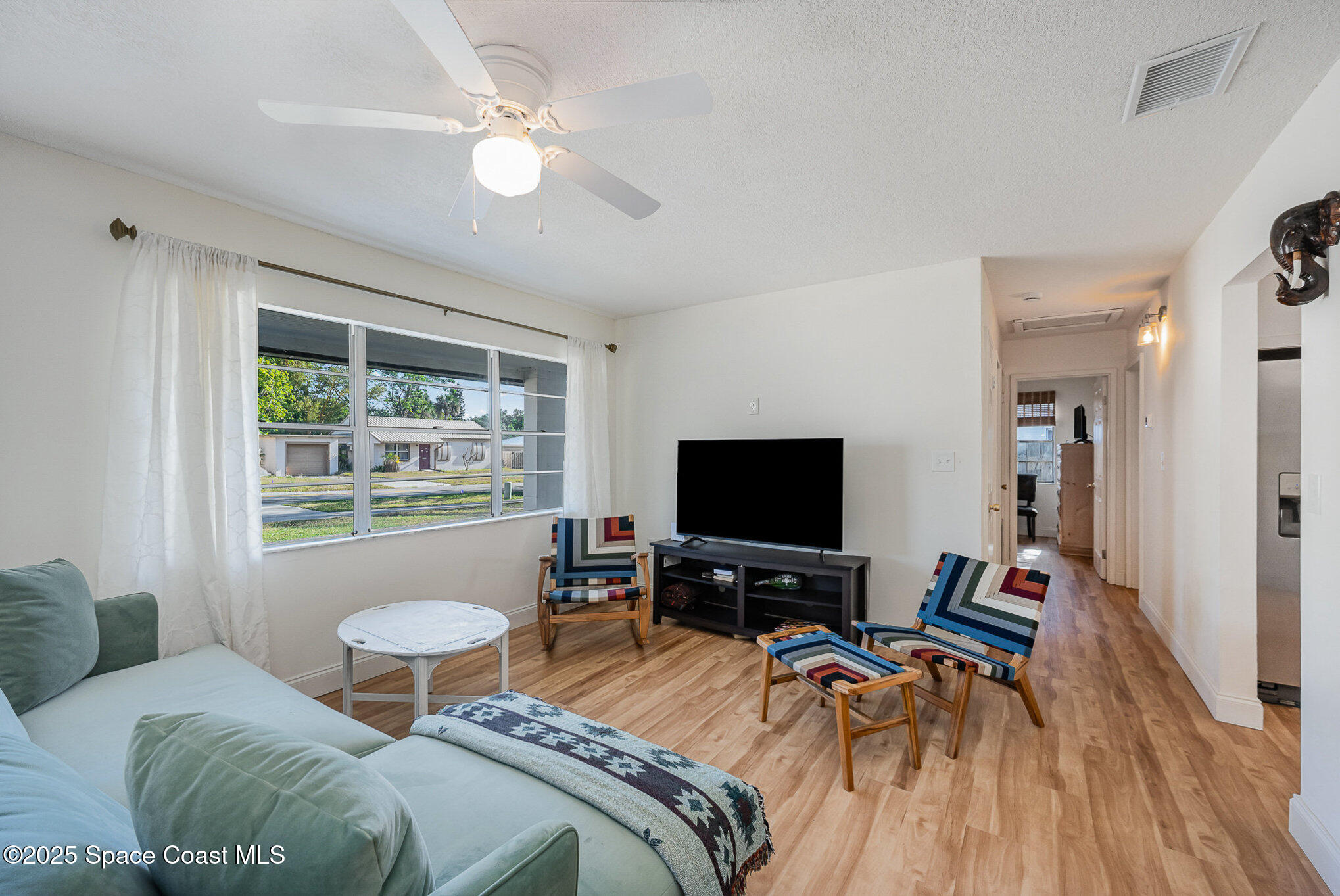 233 Beverly Road Cocoa, FL 32922 - Photo 5 of 20 a bedroom with a bed and a flat screen tv