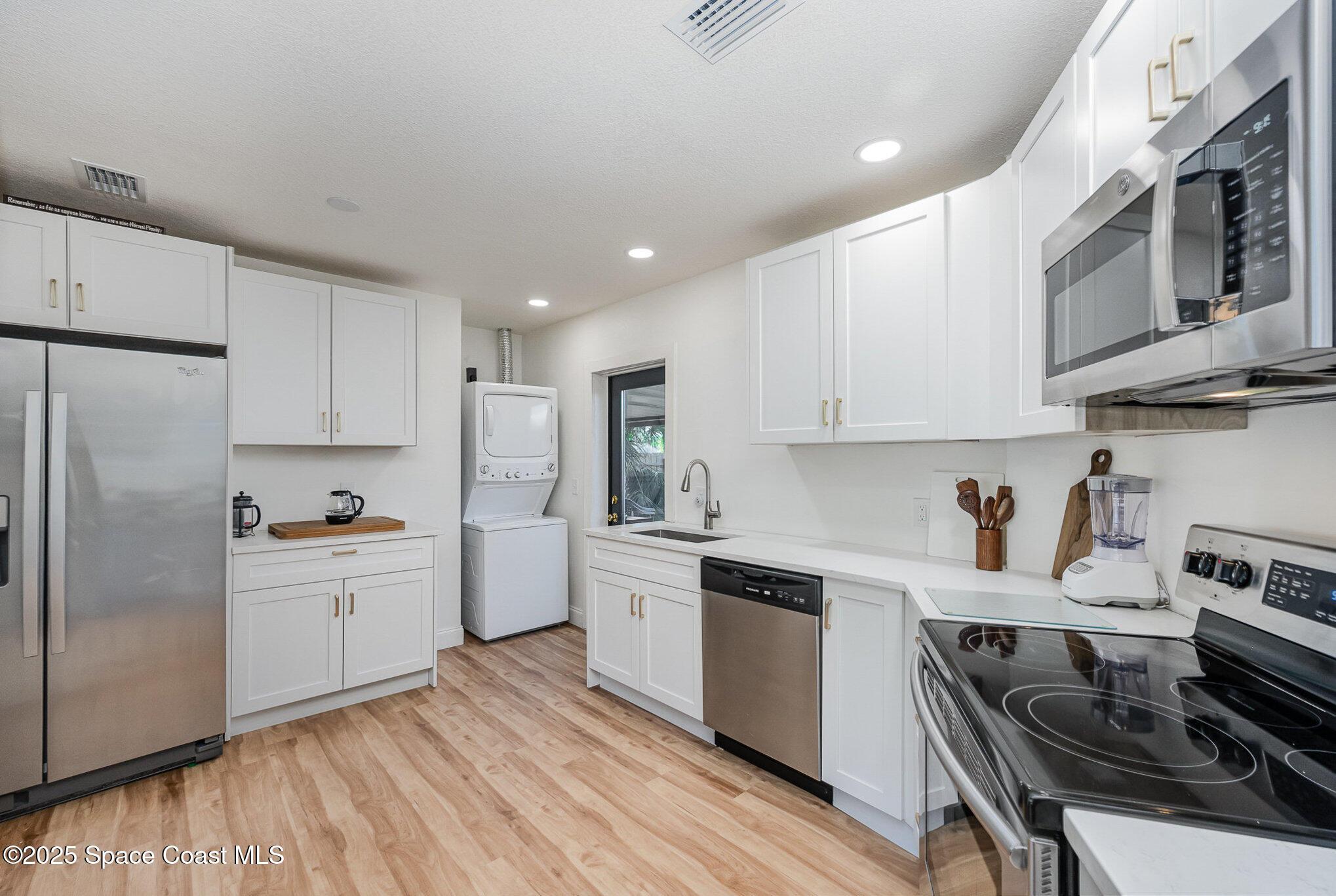 233 Beverly Road Cocoa, FL 32922 - Photo 9 of 20 a kitchen with stainless steel appliances granite countertop a stove and a refrigerator