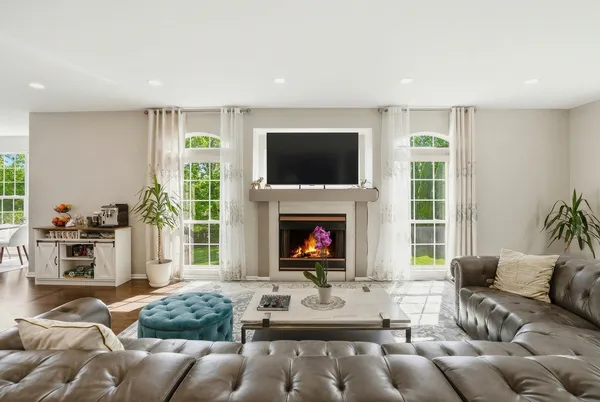 a living room with furniture a flat screen tv and a fireplace