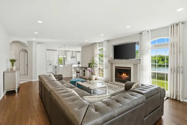 a living room with furniture a fireplace and a flat screen tv