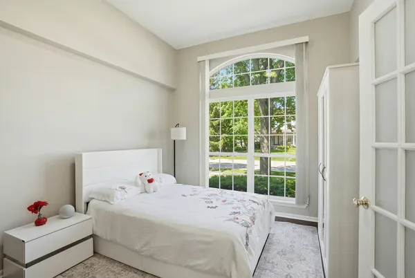 a bedroom with a bed and a window