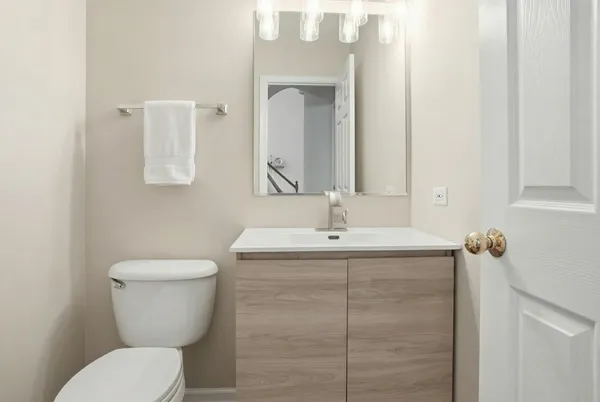 a bathroom with a toilet sink and mirror