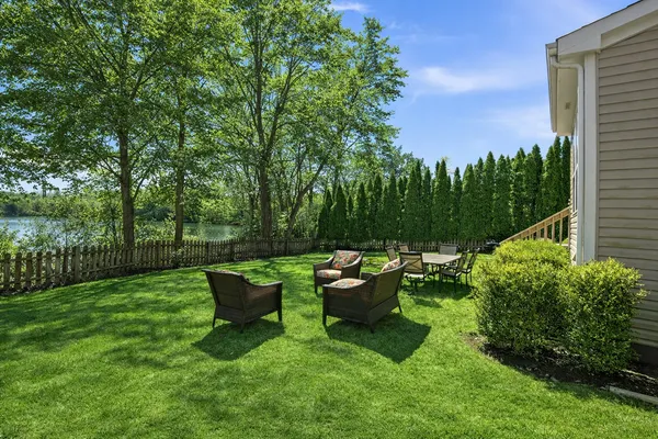 a backyard of a house with fountain table and chairs