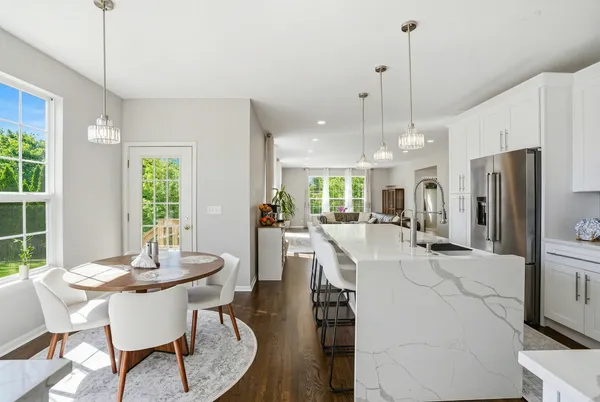 a dining room with furniture a chandelier and wooden floor