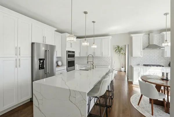 a kitchen with refrigerator and cabinets