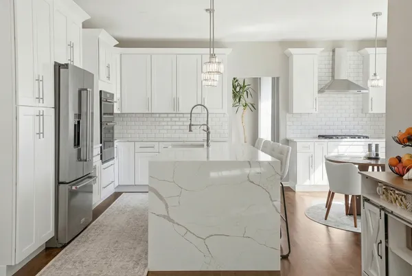 a kitchen with stainless steel appliances a refrigerator sink and cabinets