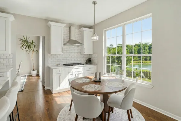 a kitchen with a table and chairs in it