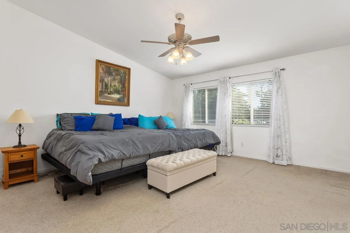 5145 Mendip Street Oceanside, CA 92057 - Photo 17 of 33 a bedroom with a bed couch and window