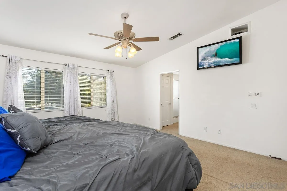 5145 Mendip Street Oceanside, CA 92057 - Photo 18 of 33 a bedroom with a large bed and a window