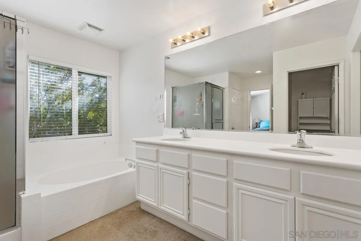 5145 Mendip Street Oceanside, CA 92057 - Photo 20 of 33 a bathroom with a tub a sink and a window