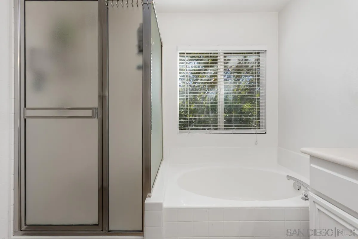 5145 Mendip Street Oceanside, CA 92057 - Photo 21 of 33 a bathroom with a bathtub and a window