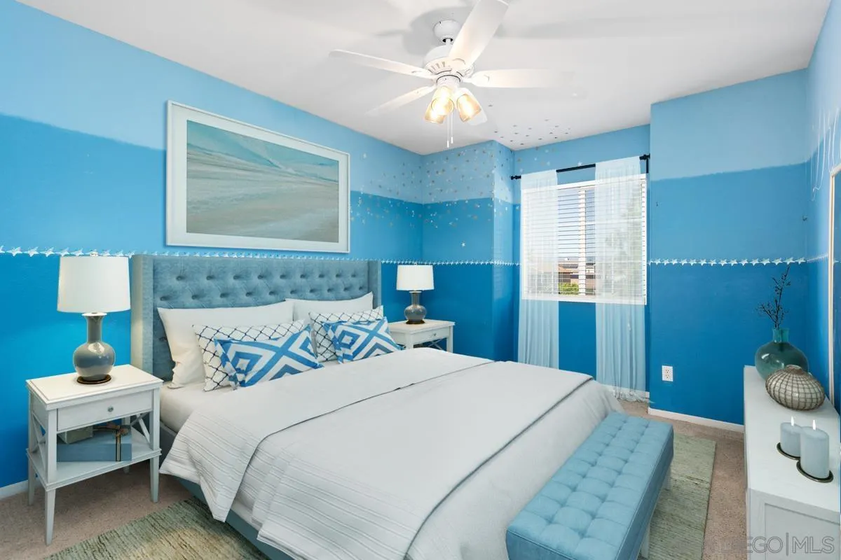 5145 Mendip Street Oceanside, CA 92057 - Photo 22 of 33 a bedroom with a bed and a lamp on dresser