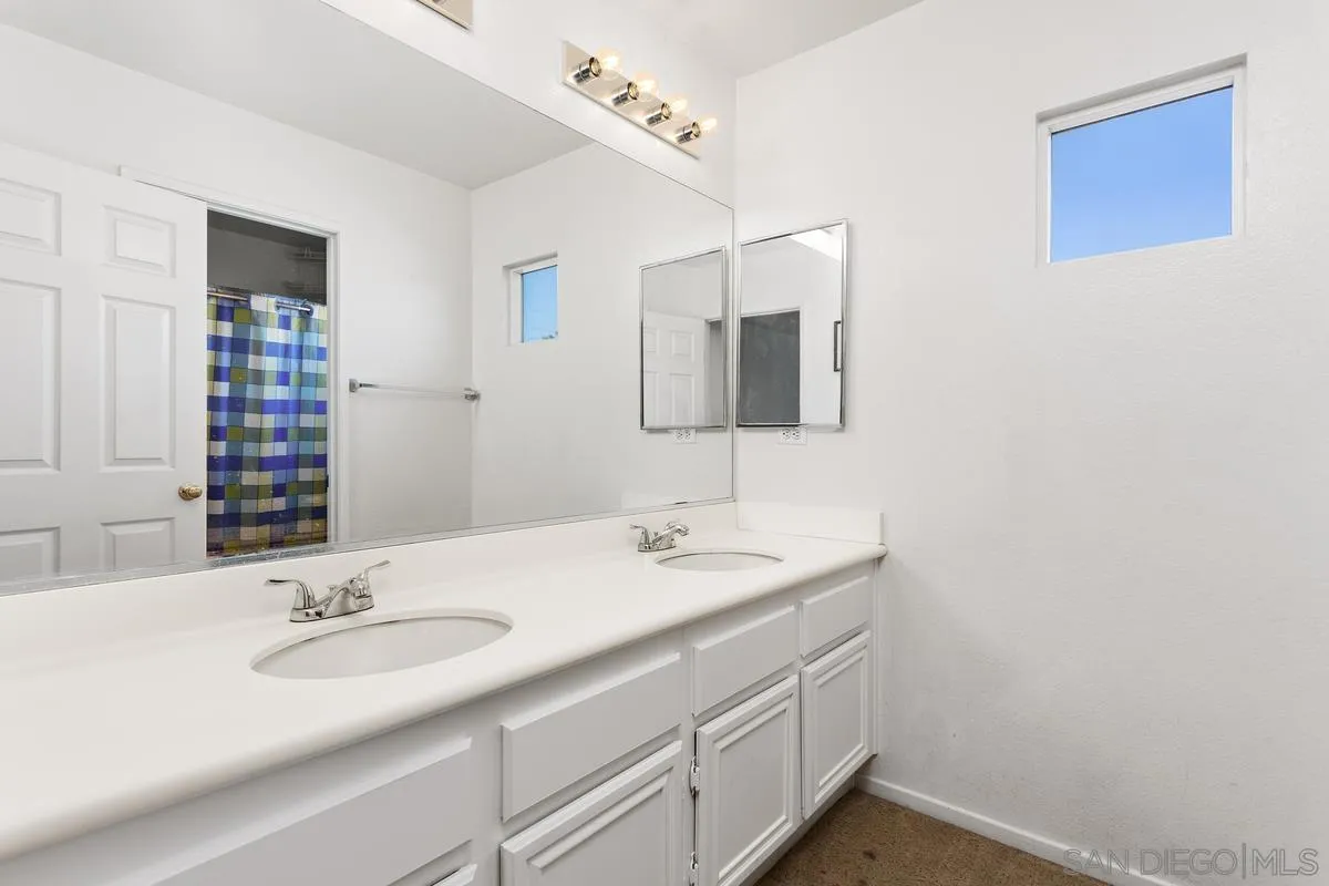 5145 Mendip Street Oceanside, CA 92057 - Photo 25 of 33 a bathroom with a sink and a mirror