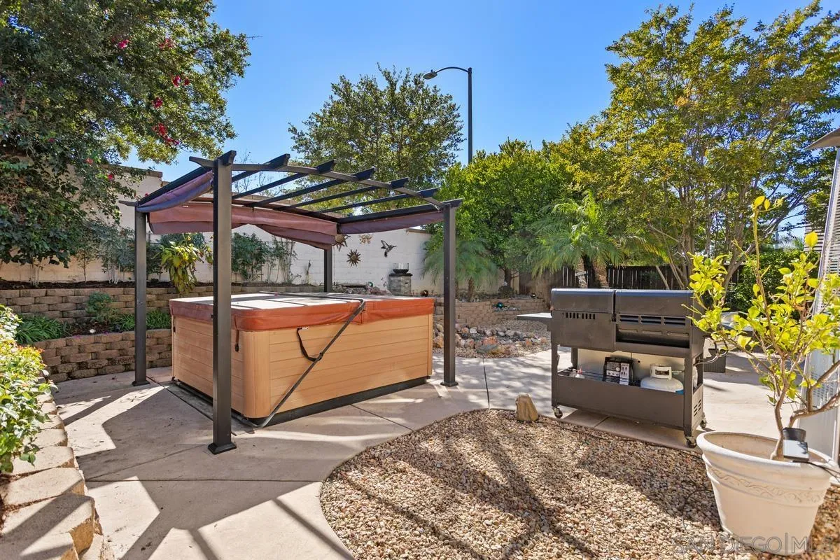 5145 Mendip Street Oceanside, CA 92057 - Photo 28 of 33 a view of a patio with table and chairs with wooden floor and fence