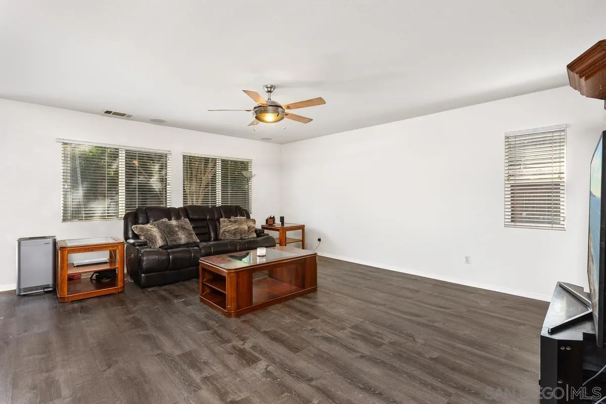 5145 Mendip Street Oceanside, CA 92057 - Photo 9 of 33 a living room with furniture and a wooden floor
