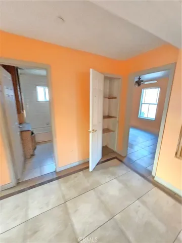 a view of a hallway to rooms and wooden floor