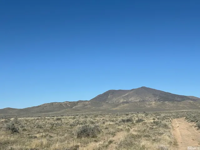 a view of a mountain range in a cloudy sky