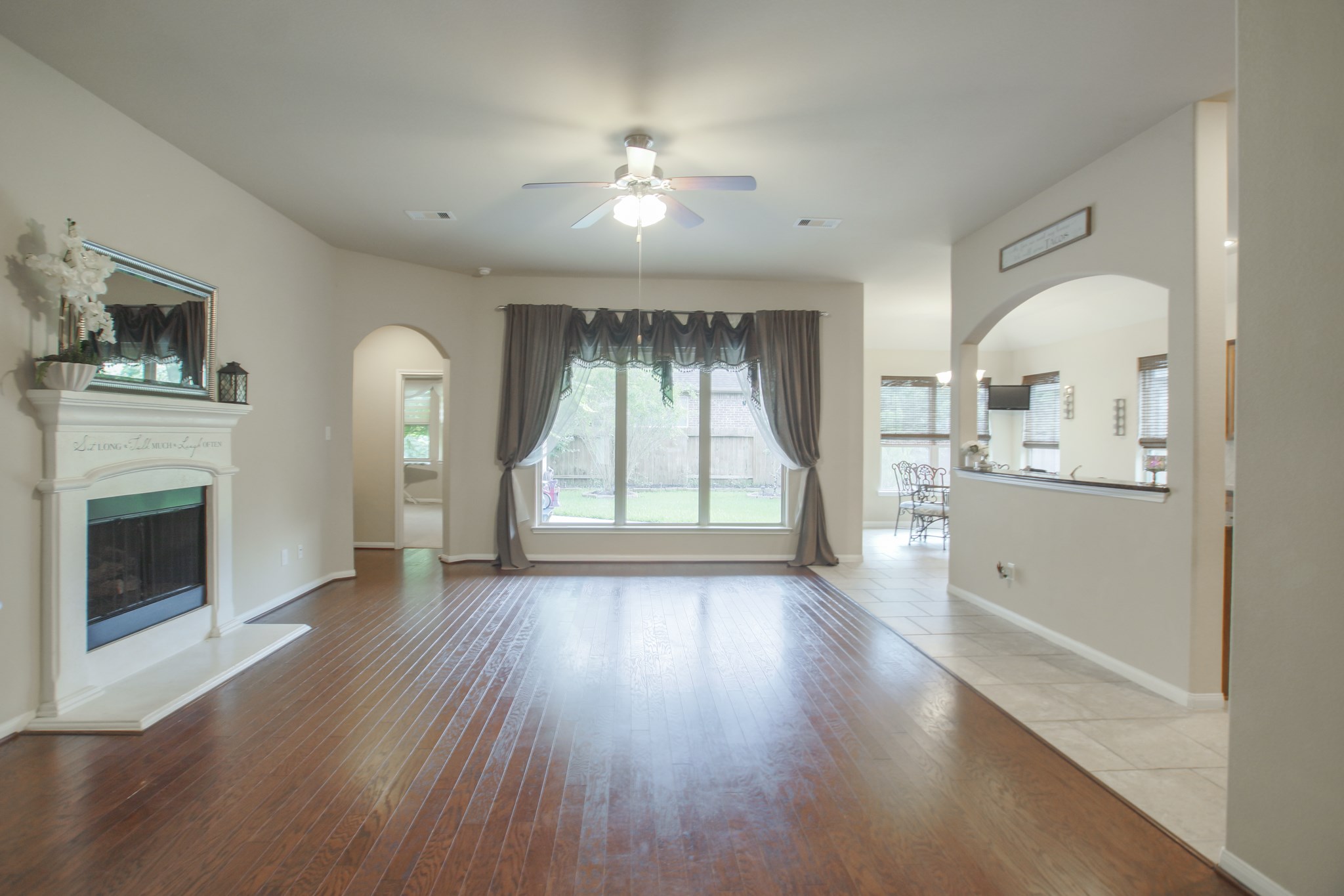 111 Pheasant Run Drive Conroe, TX 77384 - Photo 11 of 50 wooden floor in an empty room with a fireplace