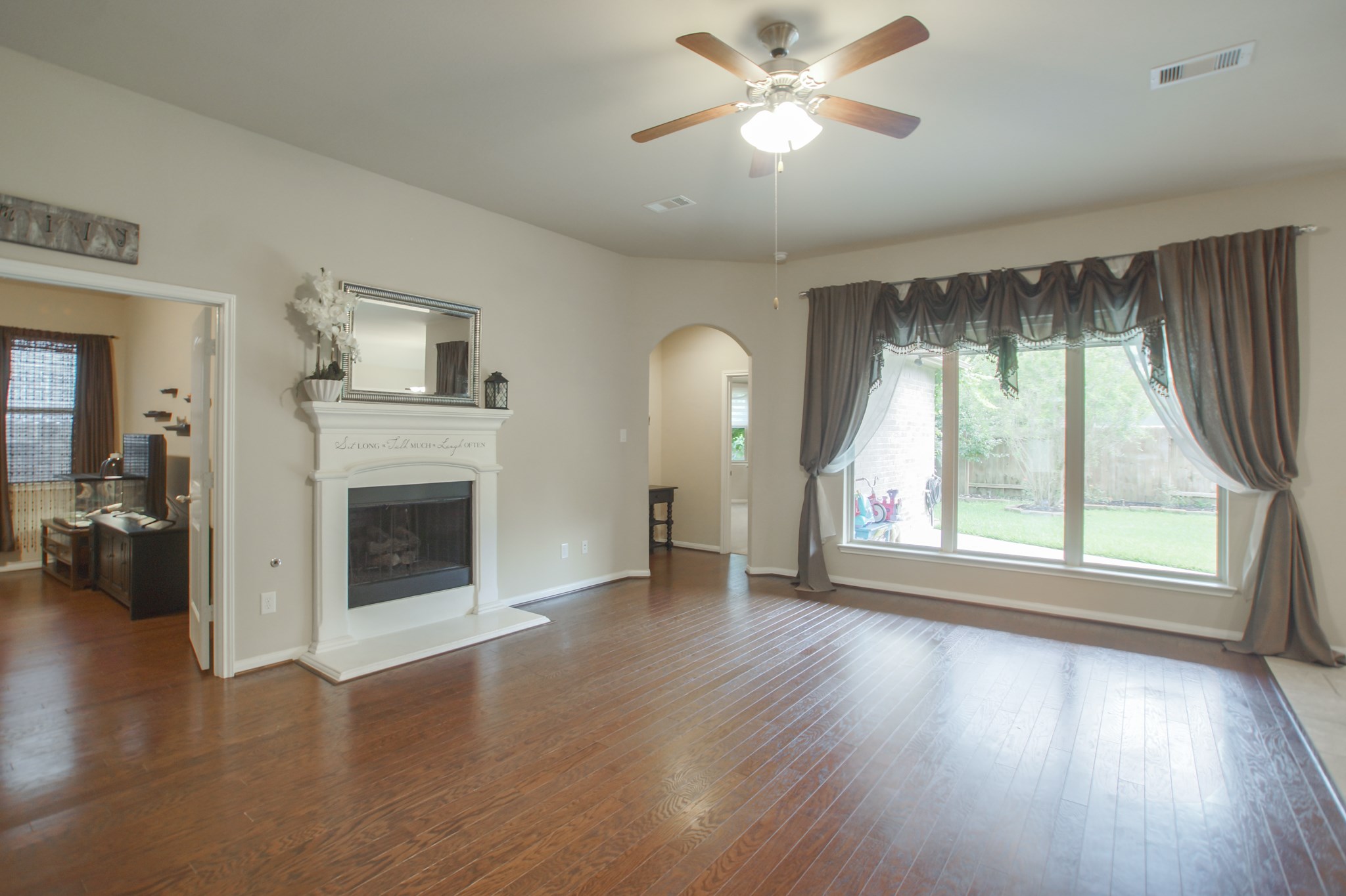 111 Pheasant Run Drive Conroe, TX 77384 - Photo 12 of 50 a view of an empty room with a window and wooden floor