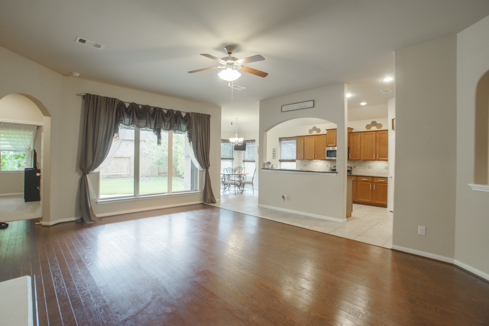 111 Pheasant Run Drive Conroe, TX 77384 - Photo 14 of 50 a view of a kitchen with a dishwasher cabinets and a large window