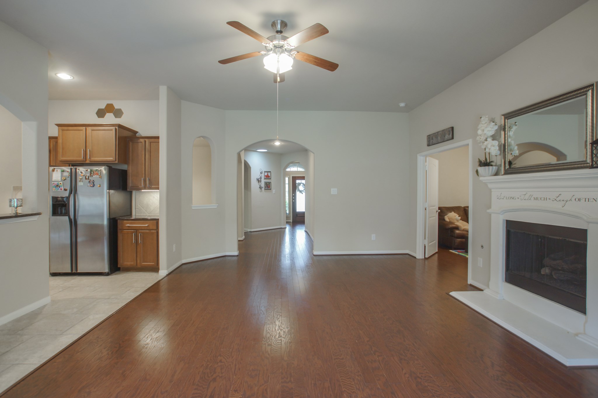 111 Pheasant Run Drive Conroe, TX 77384 - Photo 50 of 50 a view of a livingroom with a fireplace a ceiling fan and entryway