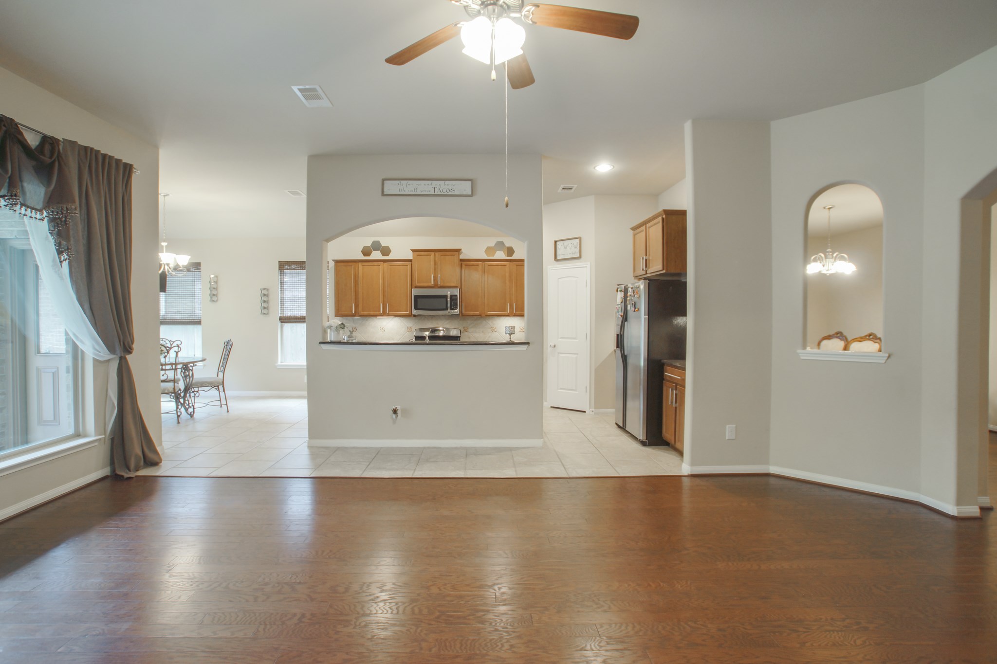 111 Pheasant Run Drive Conroe, TX 77384 - Photo 16 of 50 a view of a kitchen with a sink a refrigerator and a stove top oven