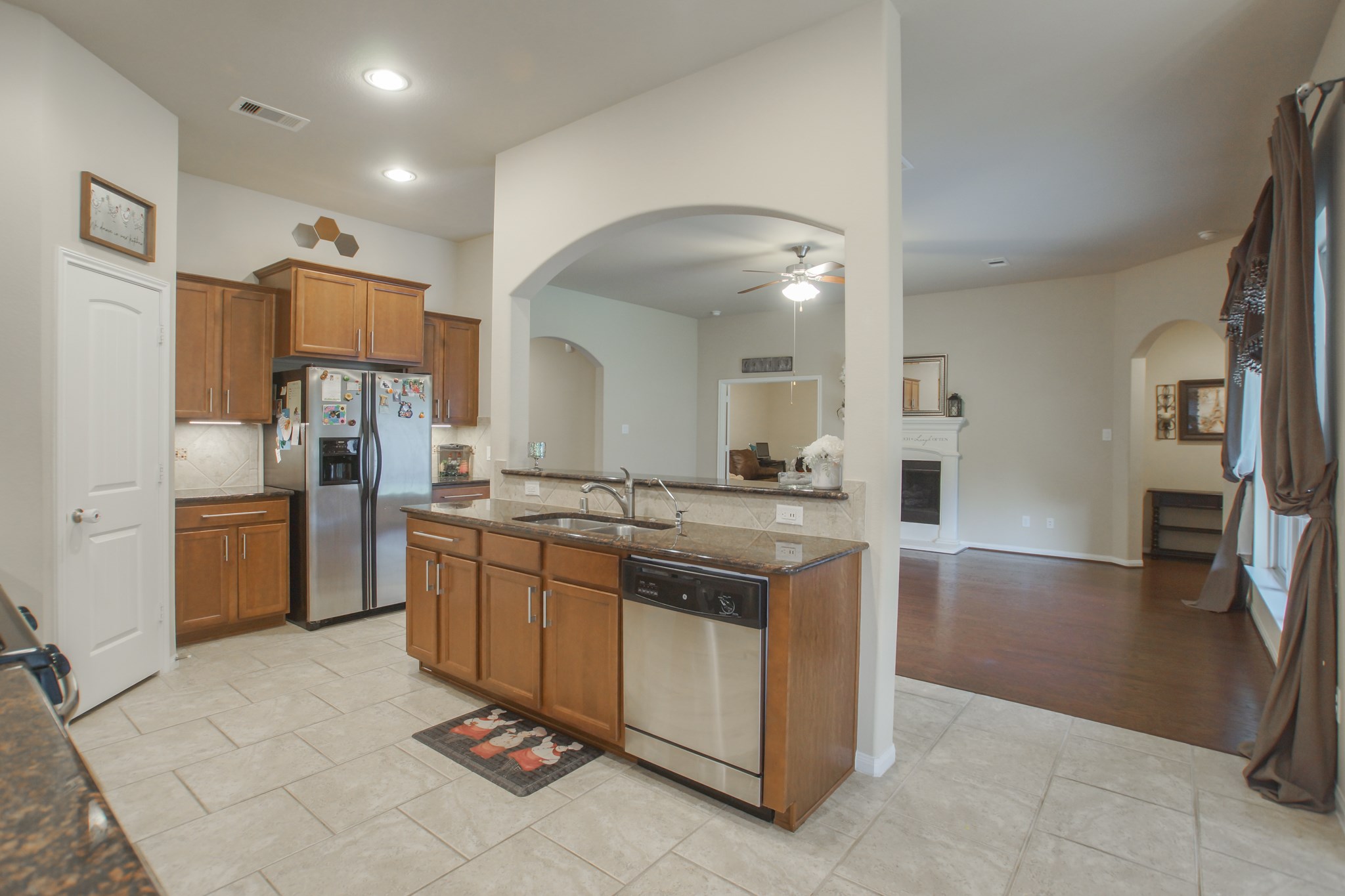 111 Pheasant Run Drive Conroe, TX 77384 - Photo 17 of 50 a kitchen with stainless steel appliances granite countertop a refrigerator and a sink