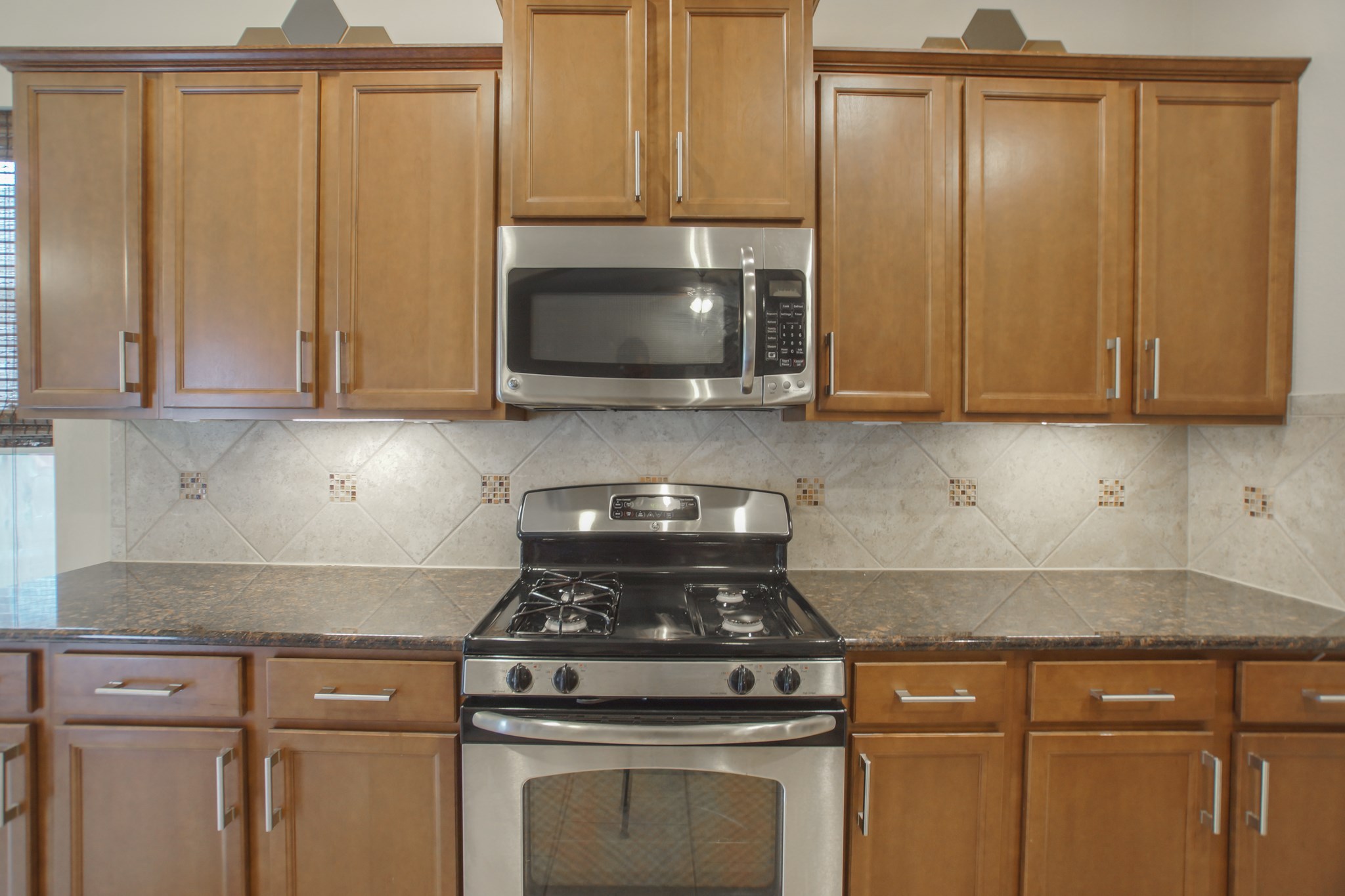 111 Pheasant Run Drive Conroe, TX 77384 - Photo 19 of 50 a kitchen with granite countertop white cabinets and stainless steel appliances