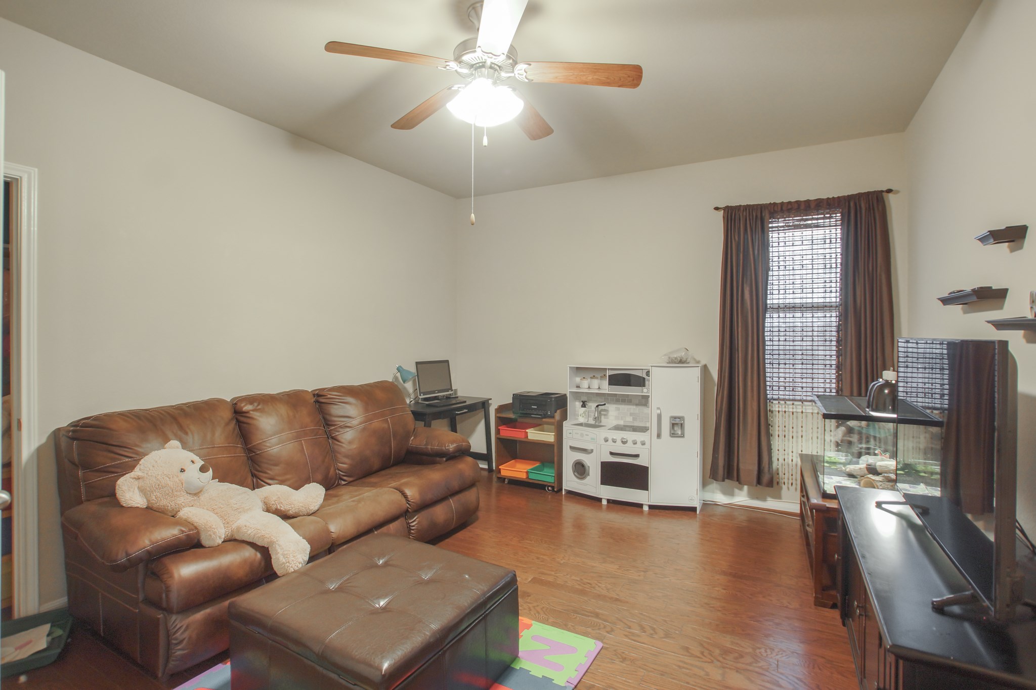 111 Pheasant Run Drive Conroe, TX 77384 - Photo 35 of 50 a living room with furniture and a flat screen tv
