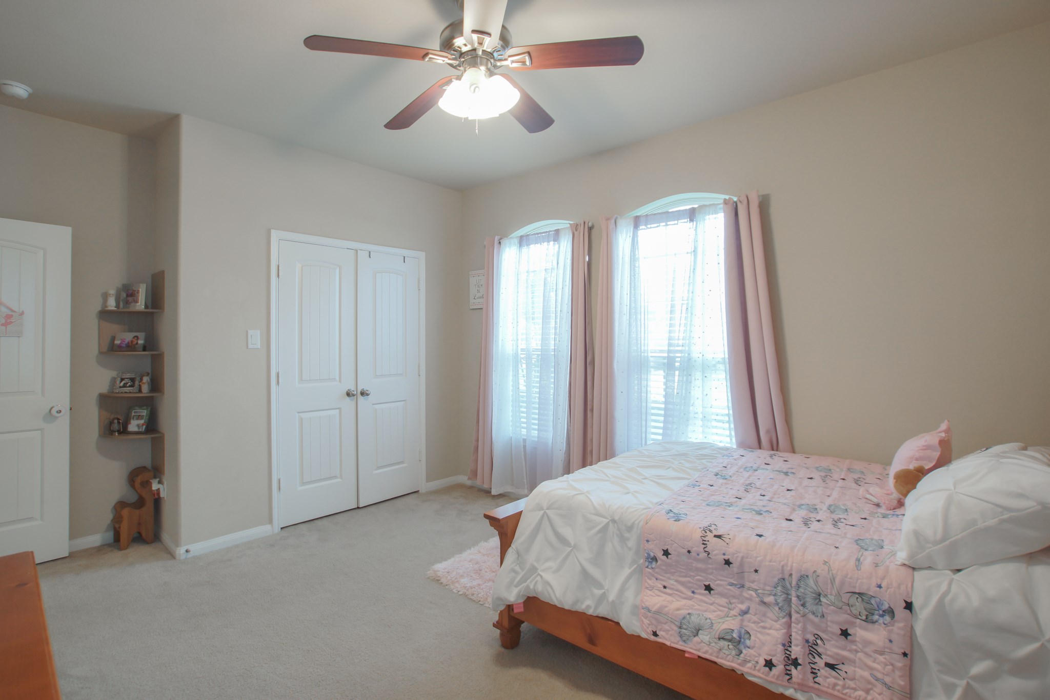 111 Pheasant Run Drive Conroe, TX 77384 - Photo 37 of 50 a bedroom with a large bed and a chandelier
