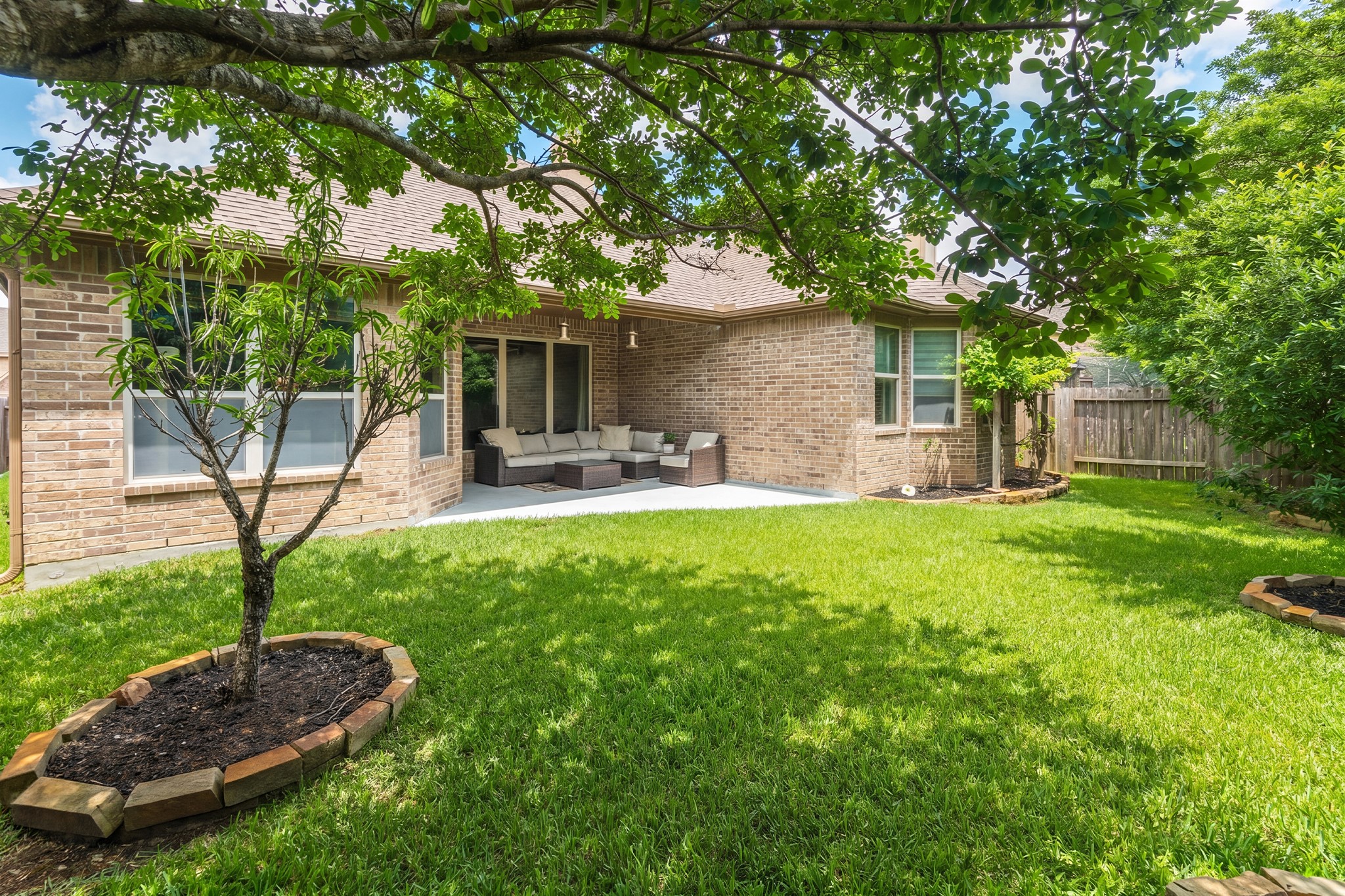 111 Pheasant Run Drive Conroe, TX 77384 - Photo 43 of 50 a front view of a house with garden and patio