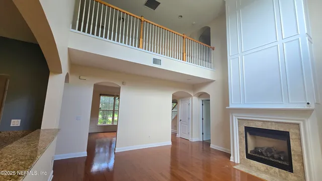 a view of entryway and hall with wooden floor