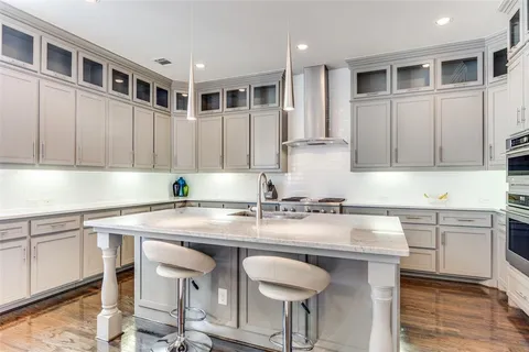 a kitchen with stainless steel appliances granite countertop a stove a sink and a refrigerator