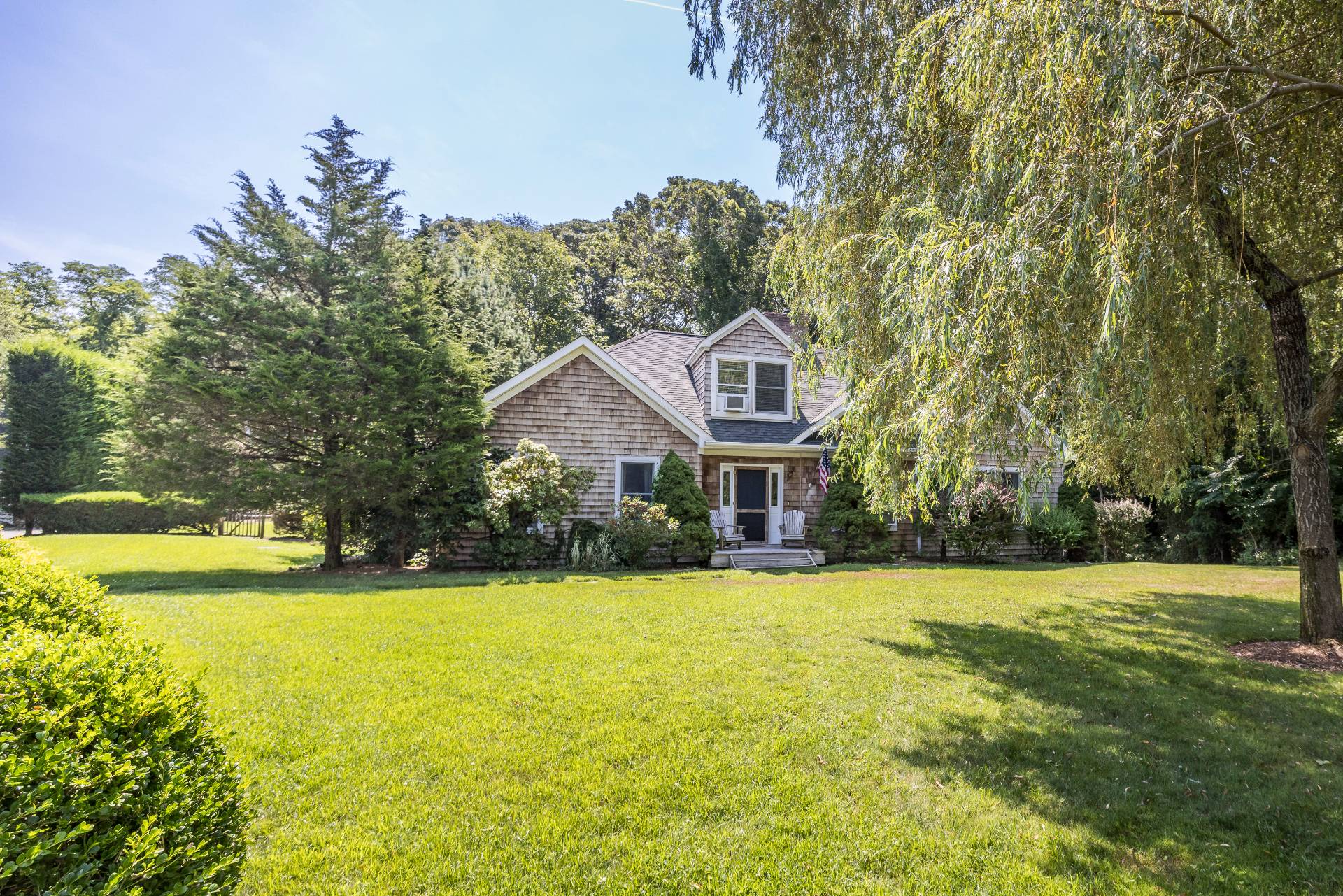 312 Noyack Road Southampton, NY 11968 - Photo 1 of 18 a view of a house with a big yard and large trees
