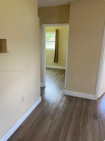 a view of a room with wooden floor