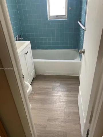 a bathroom with a bathtub and toilet