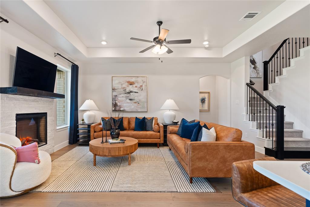 8717 Kentucky Derby Street Pilot Point, TX 76258 - Photo 6 of 18 a living room with furniture fireplace and a flat screen tv
