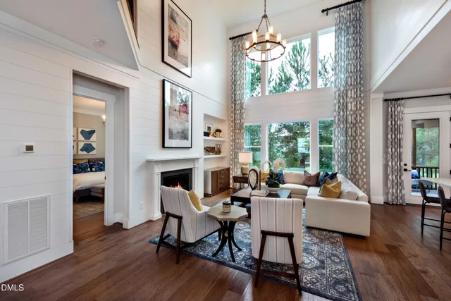 a living room with fireplace furniture and a wooden floor