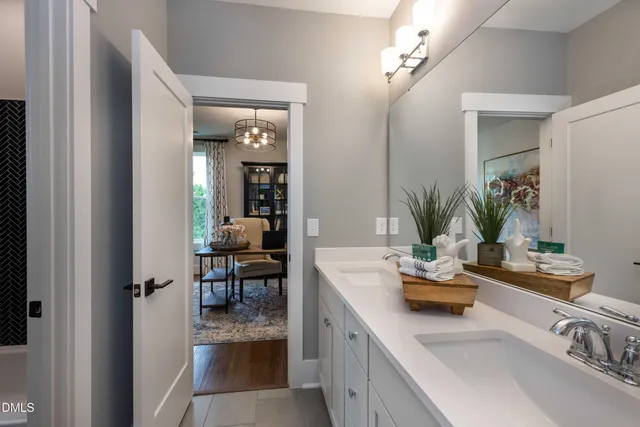 a bathroom with a sink double vanity and a mirror
