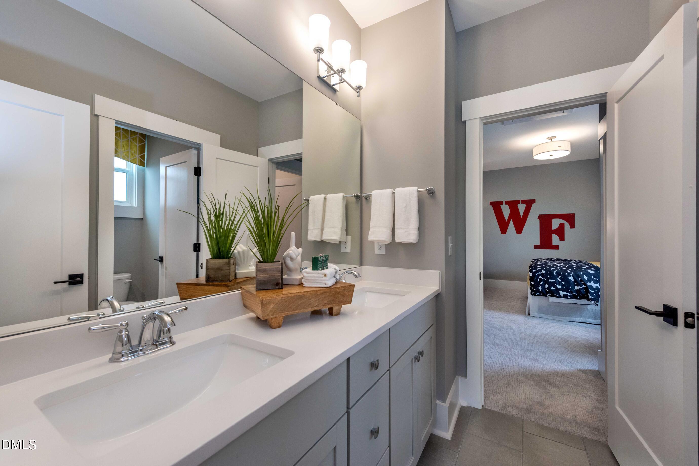 6740 St Marys Road Hillsborough, NC 27278 - Photo 24 of 26 a bathroom with a sink double vanity and a mirror