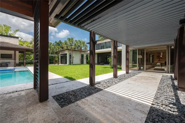 a view of a house with backyard porch and sitting area