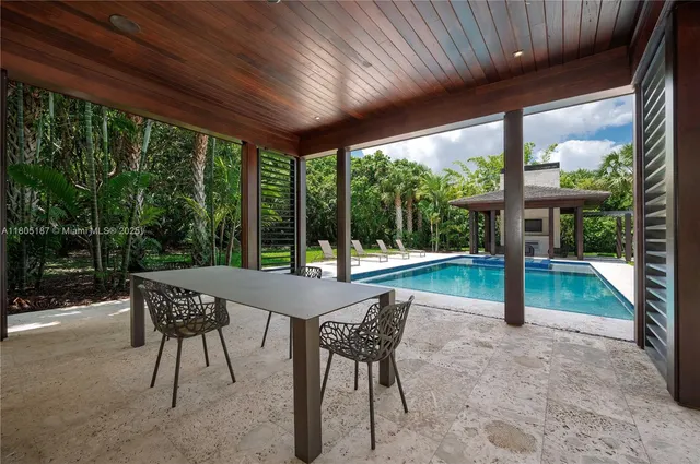 a patio with yard glass top table and chairs